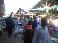 ウガンダの首都カンパラにある国内最大の公設マーケット。食品、衣料(大半が輸入古着)・靴、日用品・道具類など。いつも大勢の客と店員で犇く。
撮影：白石壮一郎、2003年